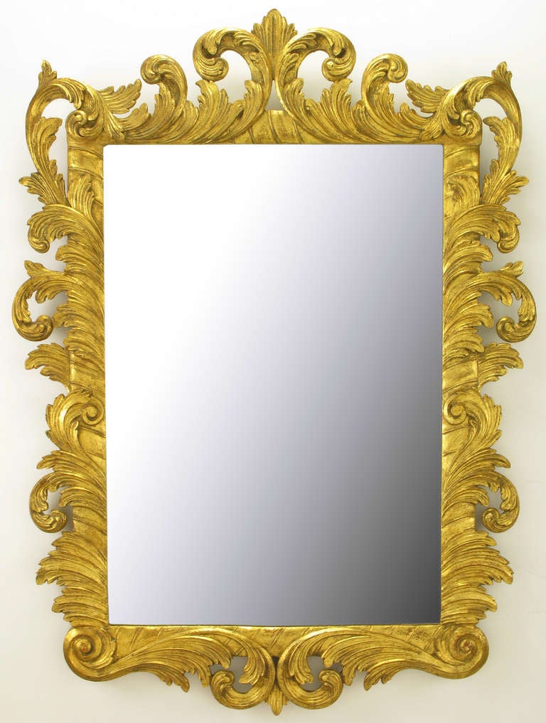 Undoubtedly of Italian origin, hand-carved wood Rococo style mirror with an exceptional gilt finish. Versatile mirror with multiple applications.