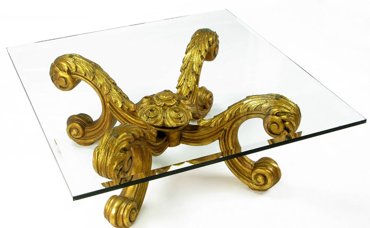 Exquisitely carved and gilt Rococo coffee table from Spain with acanthus leaf detail and large centre final. Glass top is beveled and measures 3/4