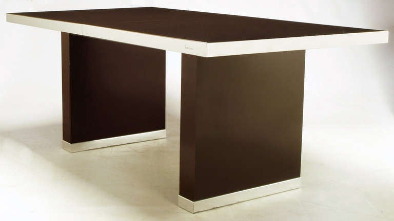 Clean lined elegance from iconic French designer, Pierre Cardin. Dark chocolate laminate over wood with chrome banding covering the edge of the table top and pedestal bases. Very well cared for it's entire life. Comes with two 18