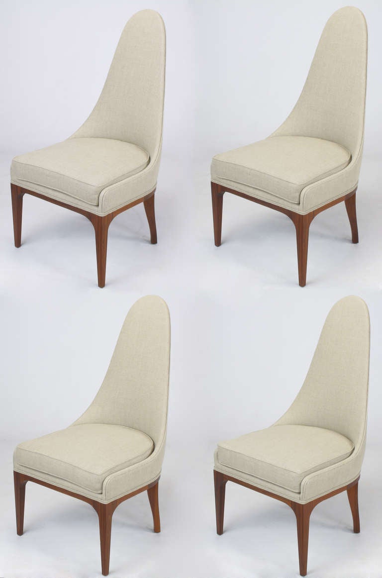 Set of four tall spoon back chairs with rosewood legs and apron. Restored in unbleached linen with new upholstery materials. Excellent profile with radius corner slipper sides and curved barrel style back. Almost identical to chairs of the same era