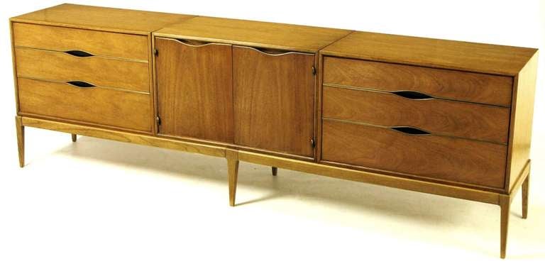Bleached walnut and brass detailed long dresser by Vignola Furniture, Chicago Il. Modular cabinets are fitted into the six leg base. Drawers open via the black lacquered 