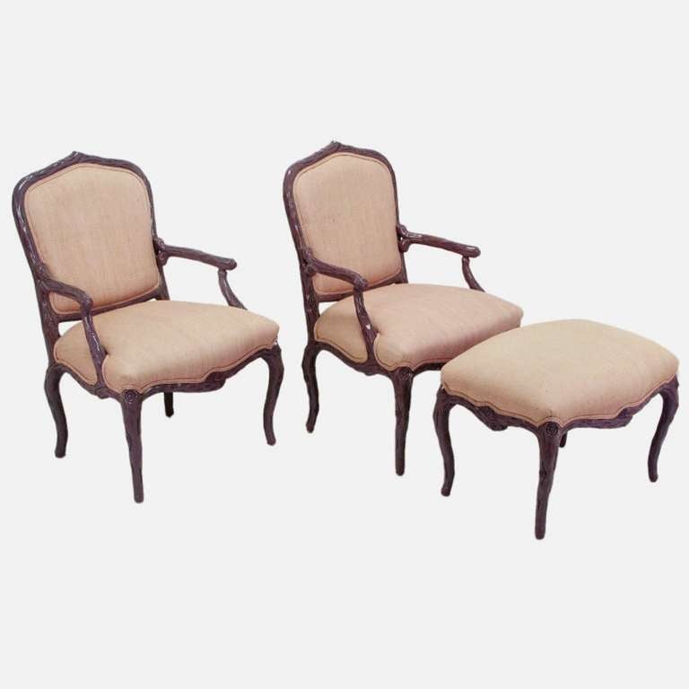 Pair of dark lavender-purple lacquer and puce silk/linen upholstered Louis XV style faux bois armchairs, with matching cabriole legged ottoman. Very well constructed with hand-carved hardwoods and high end tactile upholstery. From Casa Stradivari, a