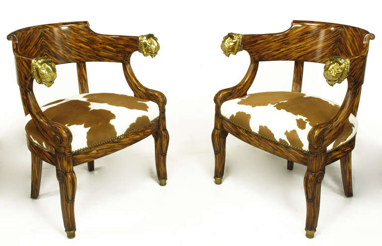 Pair of uncommon empire revival, intricately painted faux rosewood grained armchairs with solid brass lions head arms. Wood grain is stunningly natural looking, and only upon close inspection does one realize it is a lacquered finish. Upholstered