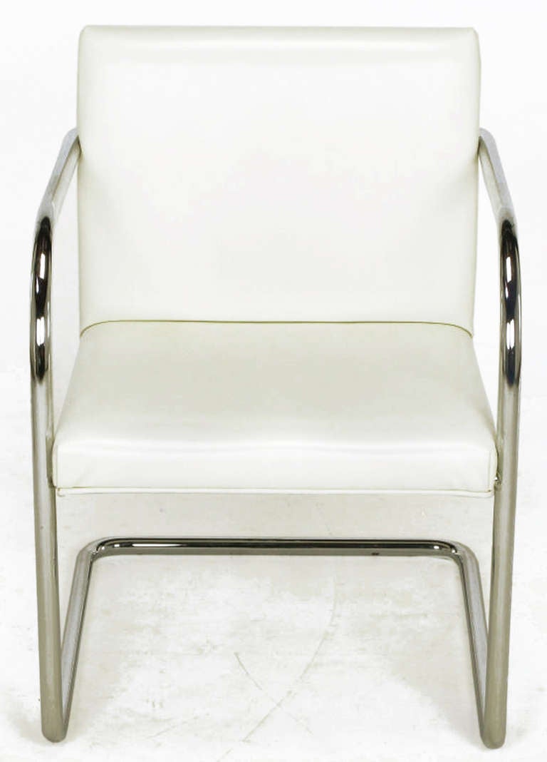 An early design of tubular chromed steel cantilevered frames, updated in this 1970s version. Single piece of tubular chromed bent steel, wood framed seat and back covered in white leather-like vinyl.