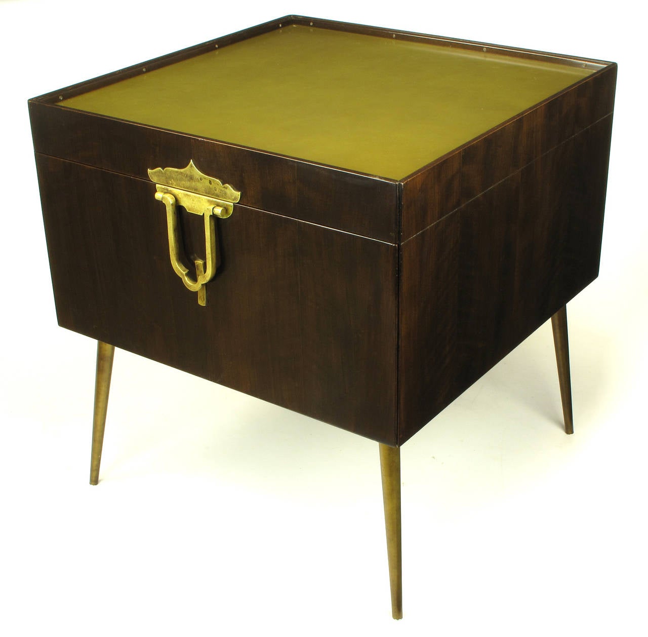 Often misattributed to Monteverdi Young, this bar cabinet constructed of walnut woods, solid brass, and anodized aluminum is actually designed by Bert England for his John Widdicomb Furniture Orientation Group. A single door is accessed by a large