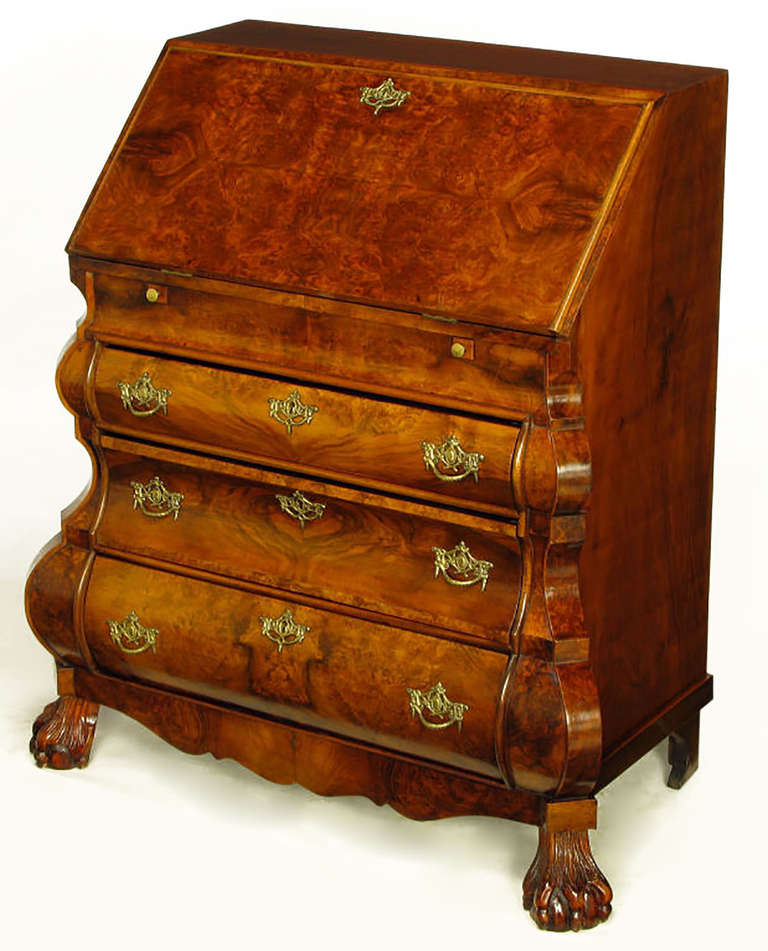 Dutch rococo style burled walnut bombe front secretaire with carved ball and claw feet. Three drawers with cast brass pulls and cast brass detailed key holes. Drop front top door opens to reveal a tooled leather writing surface and serpentine burl