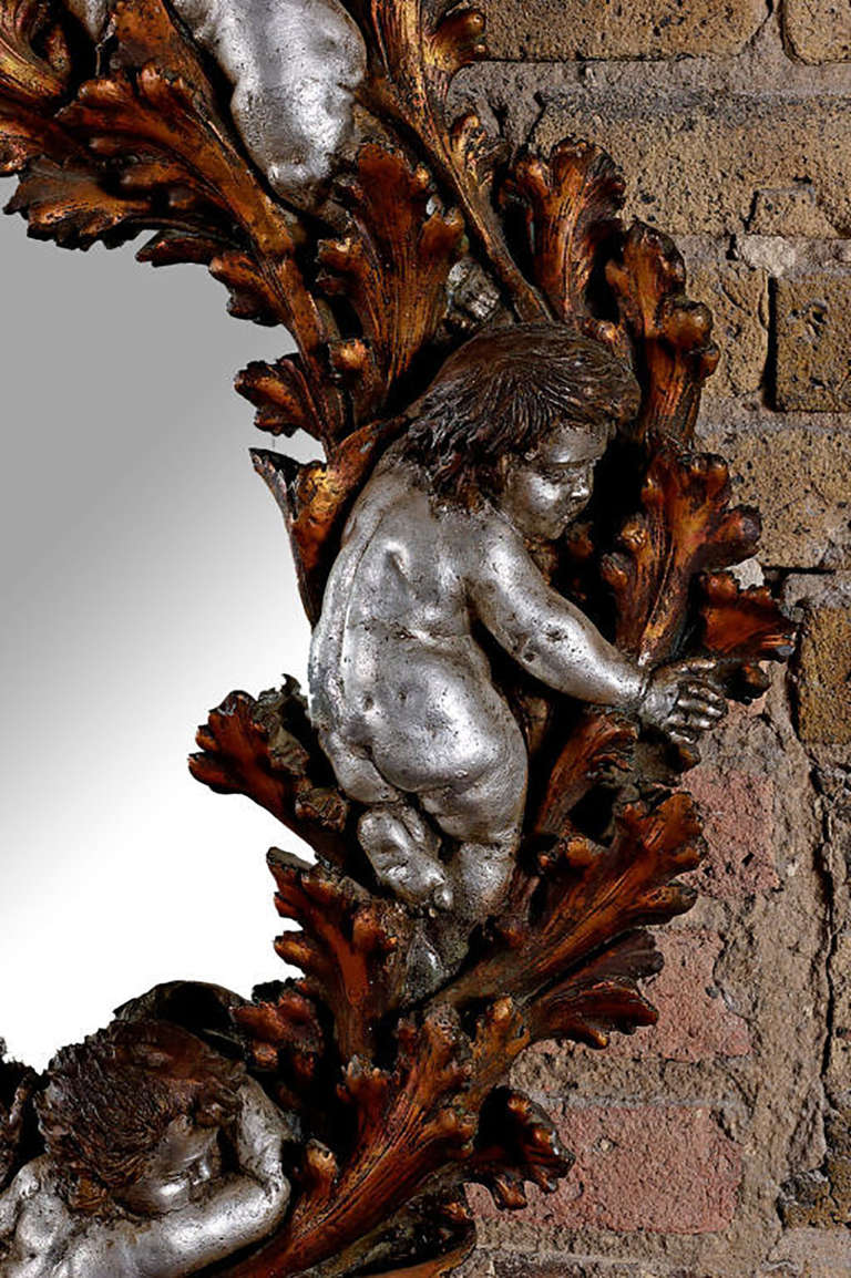 American Copper and Silver Leaf Round Mirror with Foliate and Putti Detail