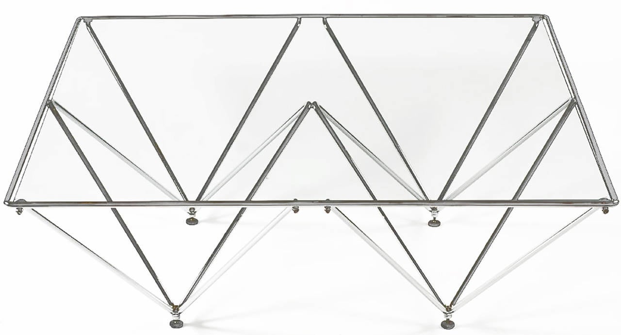 Supported by chrome metal structures shaped as inverted pyramids, this table has a clean and light look. Evocative of a Paolo Piva design, at an affordable price.