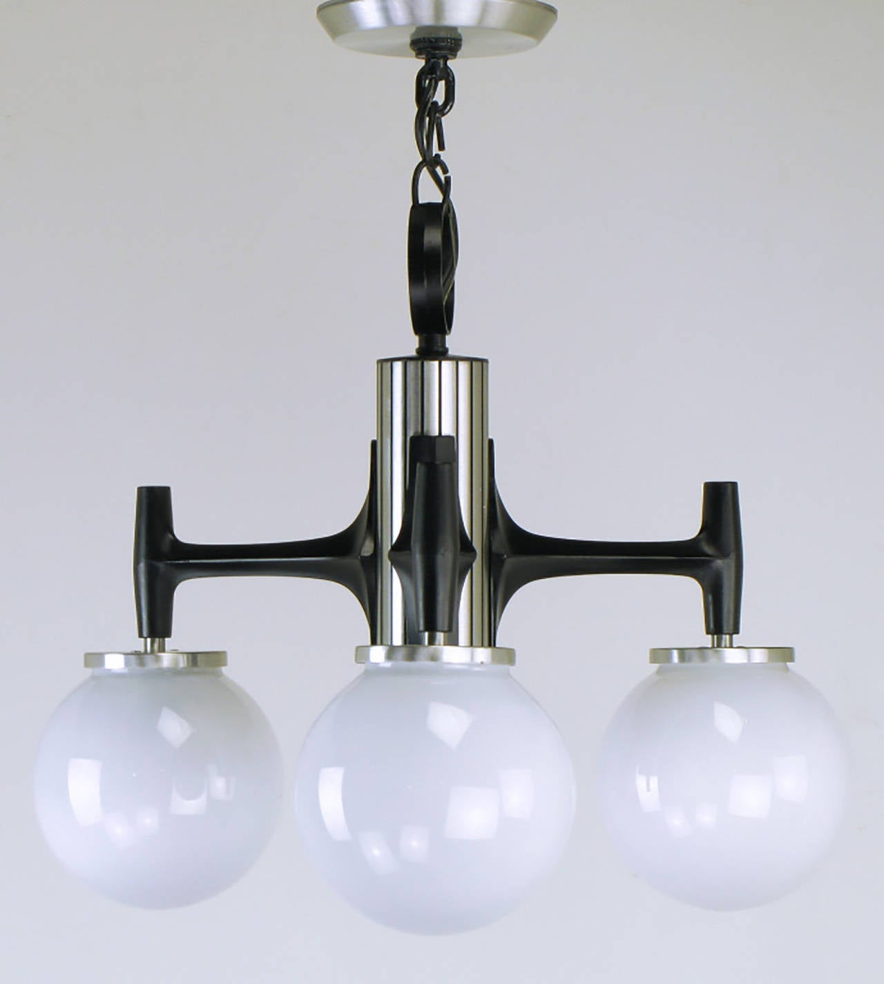 Litecraft of California milk glass triple globe hanging light fixture. Constructed of cast and brushed aluminum. Cast and black enameled aluminum arms with brushed aluminum fitters. Center cylinder is brushed aluminum with incised and black enameled