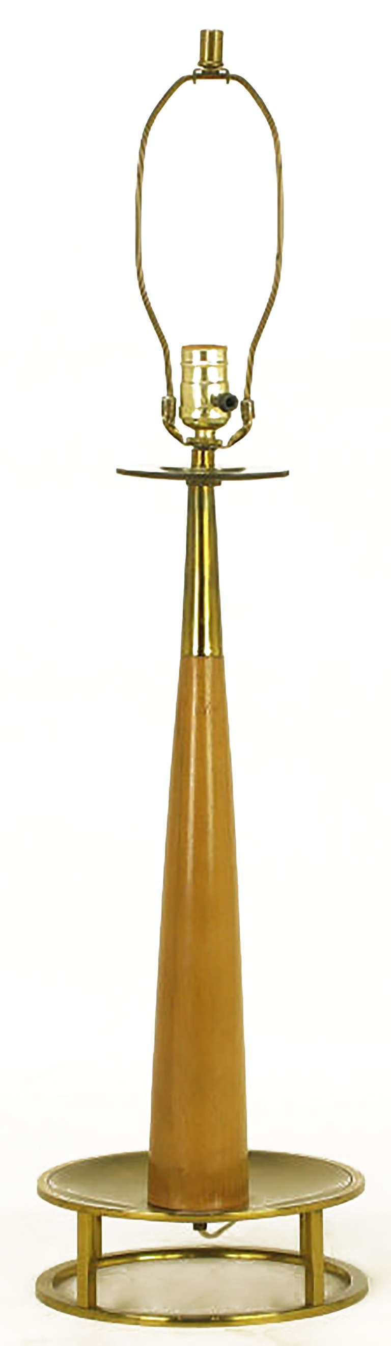 Exceptionally designed mahogany and brass open base table lamp by Stiffel. Tapered mahogany body topped with a brass stem and brass bobeche. Brass base is an open circle with four brass bar legs and brass incised border dish. Brass socket and harp.