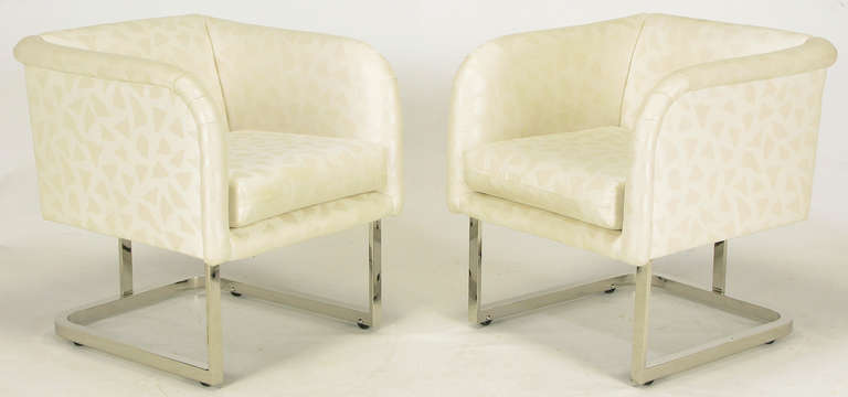 Pair of Milo Baughman for Thayer Coggin soft cube form club chairs. Nickel over steel base has the appearance being cantilevered yet with the addition curved center support and integral casters. Loose seat cushion and slightly rolled arms and back