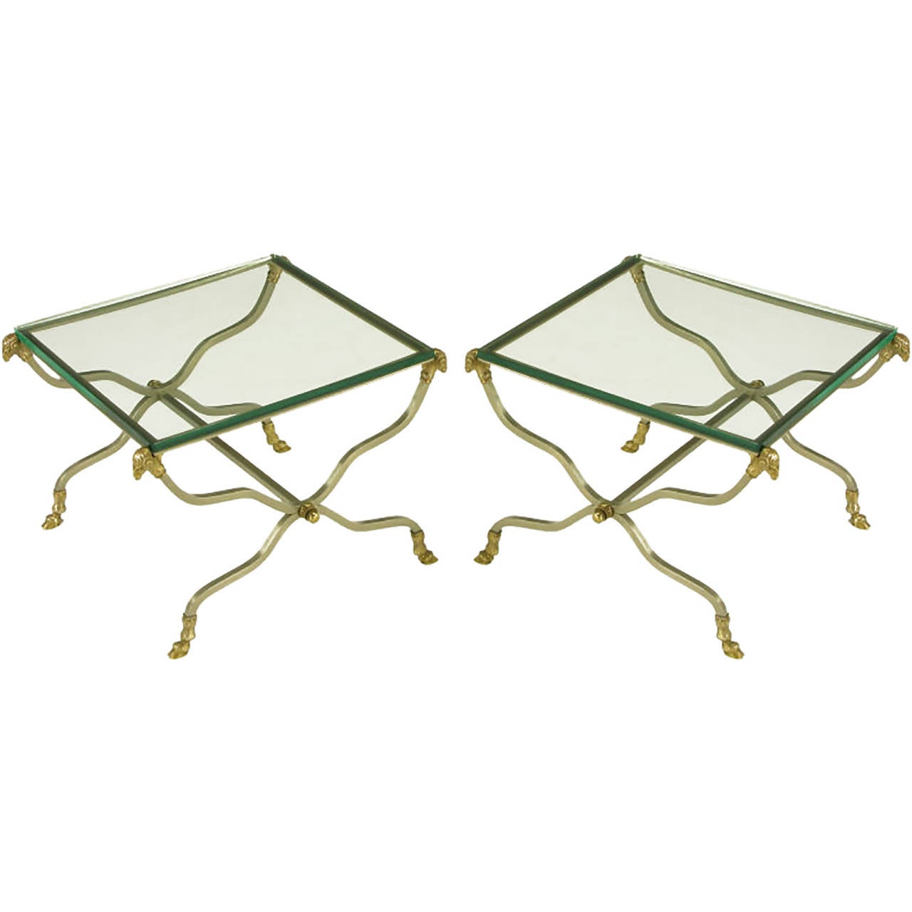 Versatile pair of square tables, with undulating X-form bases. Each table has square brushed steel legs terminating in a cast brass ram's hoof, and the each upper support is surmounted by a cast brass ram's head. Cylindrical steel stretchers are