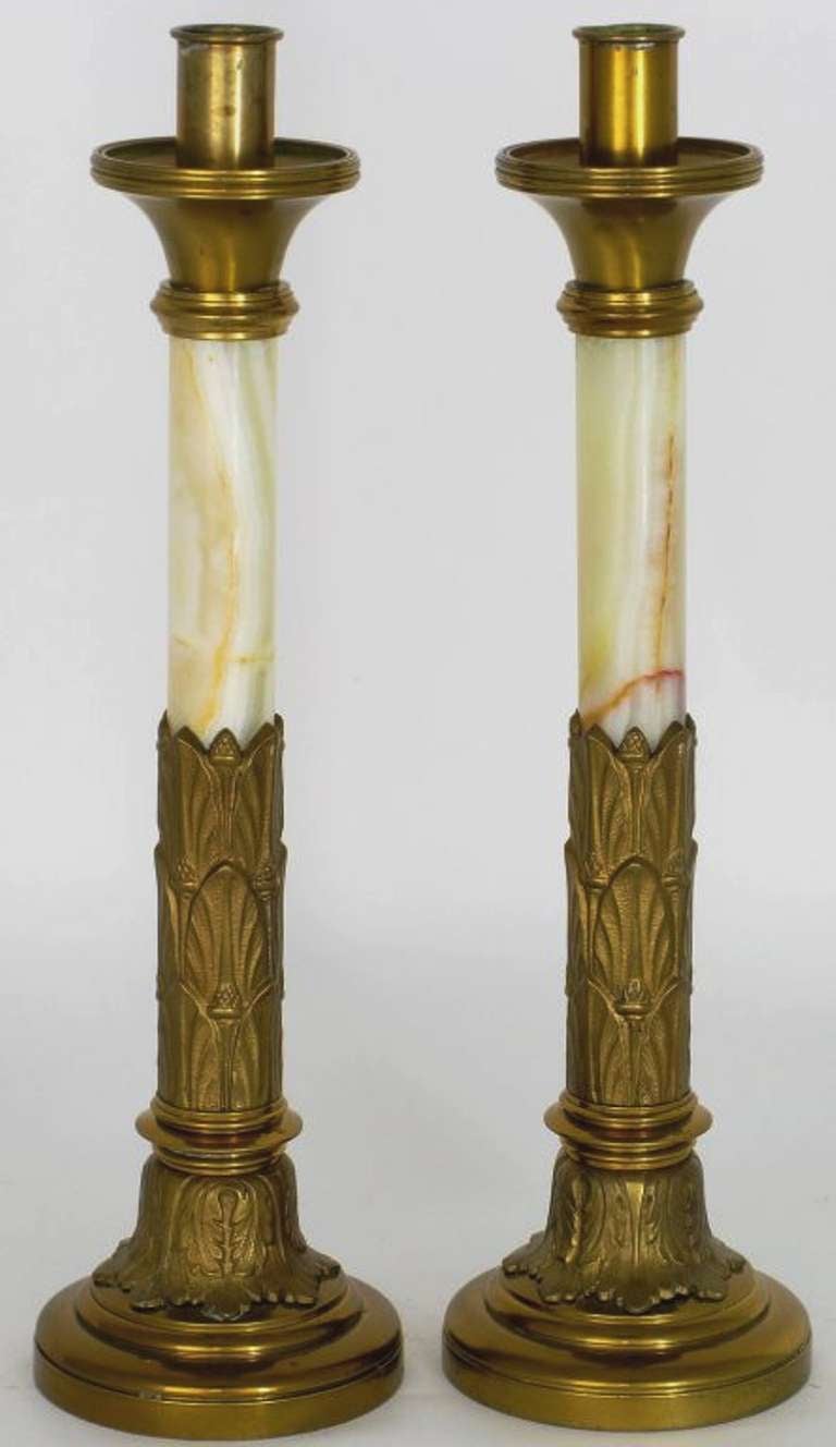 Well executed with light onyx columns and aged patinated brass, these elegant Art Deco candle sticks would look wonderful on the mantel or the dining table.