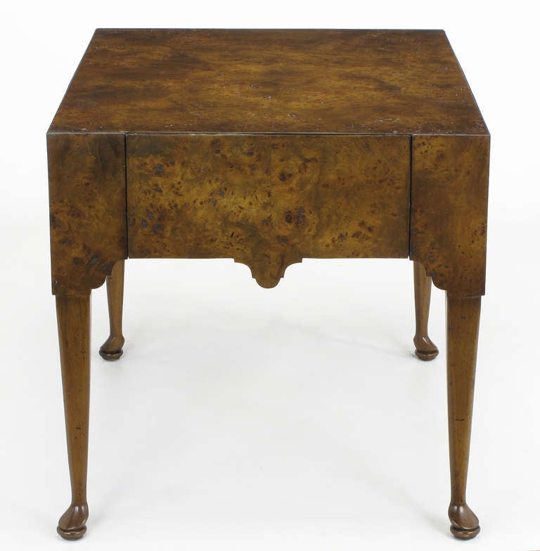A great example in textured simplicity, this clean-lined Georgian end table by Tomlinson Furniture has a burl clad top and sides with stylized walnut legs and a flush, concealed drawer.
