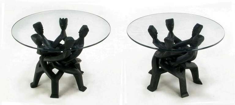 Outstanding craftsmanship and African influence make this pair of hand carved interlocking figural chain wood end tables something quite special. Each 