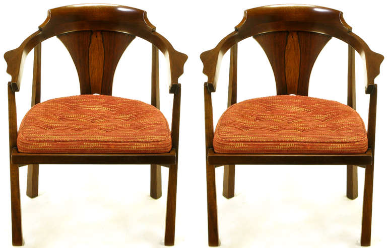 Pair of Edward Wormley for Dunbar walnut and rosewood, loose seat cushion, arm chairs. Sculpted walnut frame with scalloped arms, square tapered legs and rosewood curved and flared back panel. Button tufted striped cut chenille upholstered loose