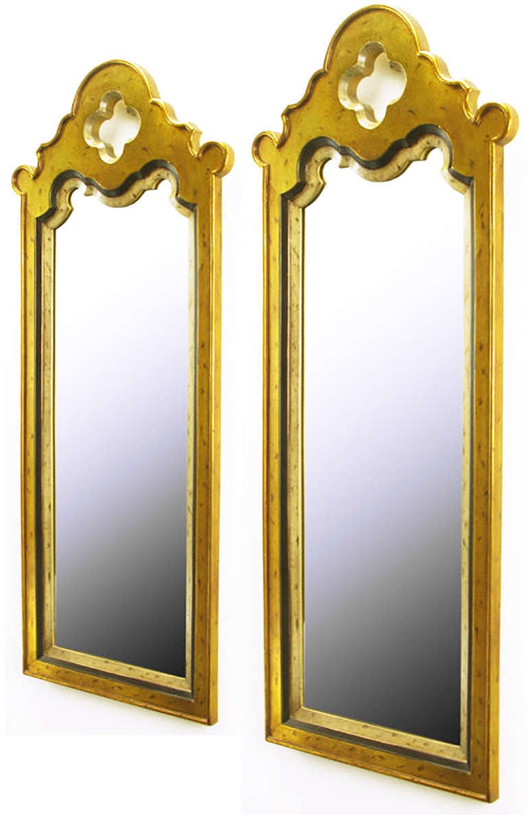 Pair of cast resin Moorish design mirrors with patinated gold and silver leaf finish. Tall and narrow with inset frame and quatrefoil top opening.