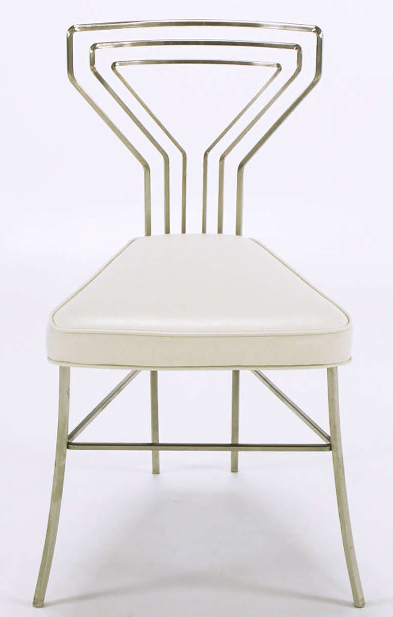 Unexpected and rare set of six bent and polished steel dining chairs with white bicast leather seats. Three part concentric shaped backs and narrow width back legs that follow the lines of the outermost back steel square bar rod.