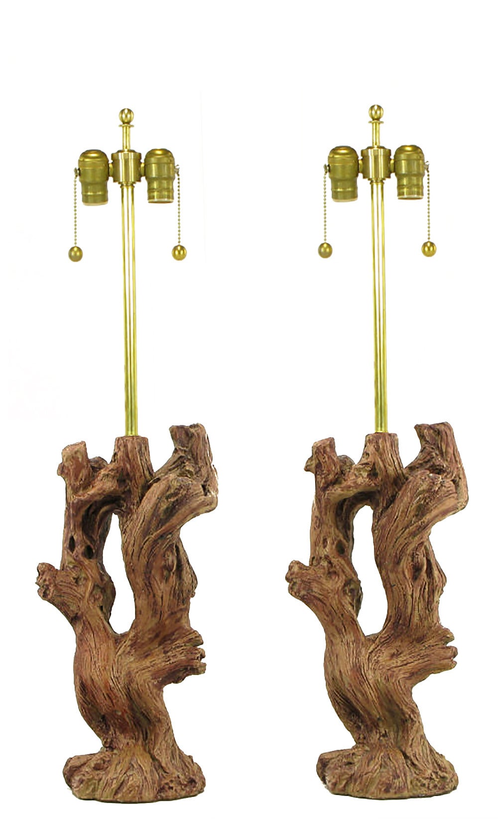 Pair of ceramic faux bois driftwood bodied table lamps with beautifully authentic glazing. Brass stem and double socket cluster, sold sans shades.