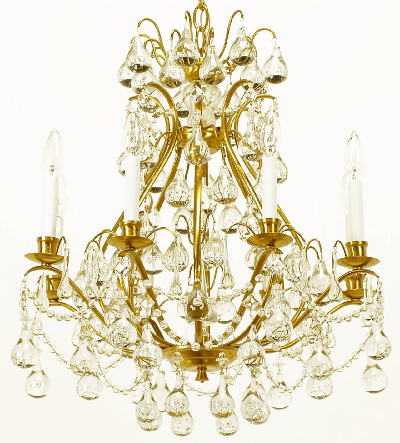 Striking eight-arm chandelier in brushed brass, with a gourd form open center, crystal swagged beading and rain drop bubble crystals adding a modern touch. Multiple tiers of crystals give the appearance of water gently dripping from the brushed