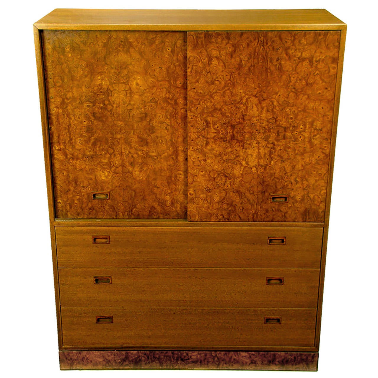 This sleek clean lined Harvey Probber gentleman's bureau features burl wood doors with recessed rosewood pulls. The doors slide to reveal three cork lined trays and four shirt drawers. Three large lower drawers come with the same recessed pulls and