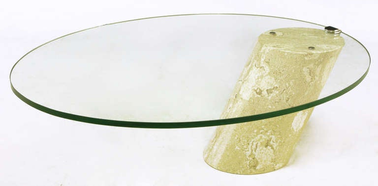 Italian marble base that protrudes from the floor at a 45 degree angle with cantilevered oval glass top. Similar in style to the Zephyr table designed by J. Wade Beam for Brueton in the 1970s. The thick cantilevered glass top is held in place with