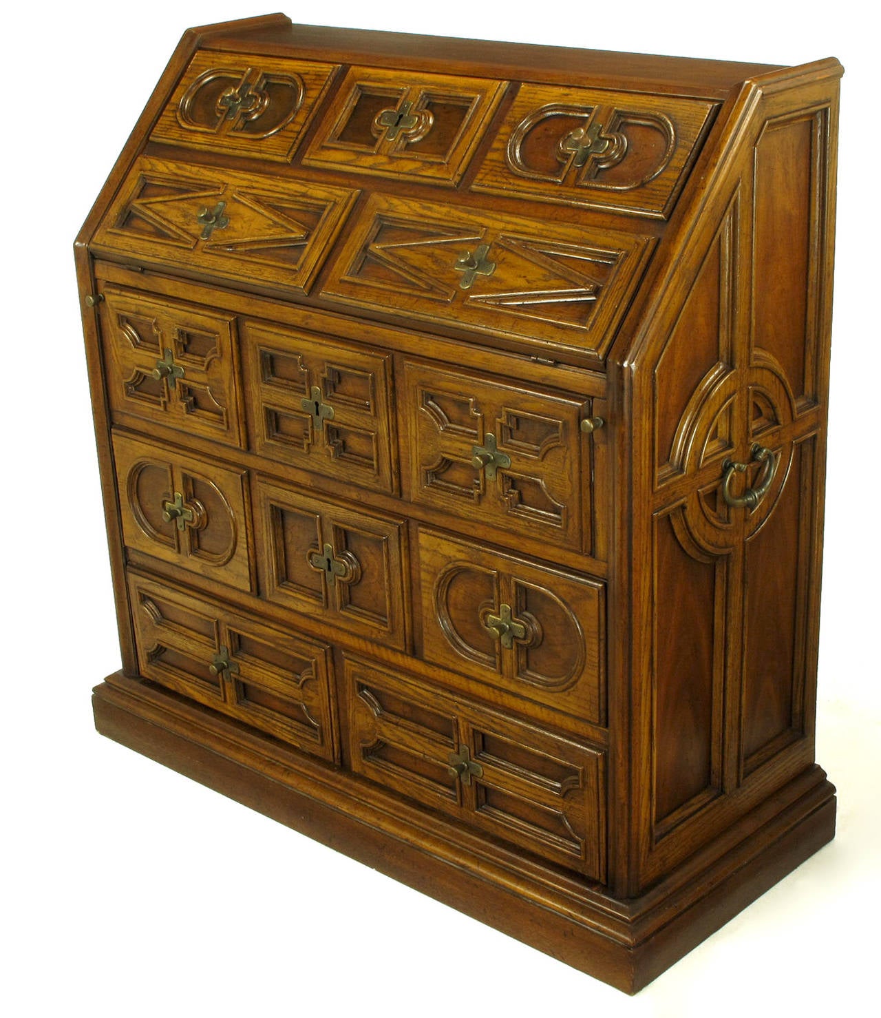 Drexel drop front desk from the Sandia Collection, circa 1960s. Interesting writing desk marrying the form of a Govenor Winthrop drop front desk with early English Jacobean style. Constructed of oak with brass handles and pulls, three full size