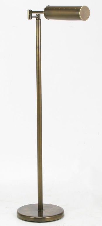 Articulated bronze finished floor / reading lamps by Walter Von Nessen. Tubular three-quarter round shades are articulated, and the arms swivel. Incandescent illumination up to 100 watts