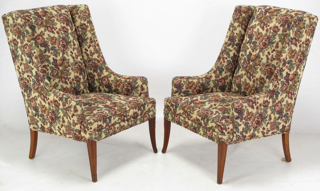 Regency low arm wing chairs with mahogany saber legs. Tapestry upholstery is a combination of grapes, pears, vines and flowers.