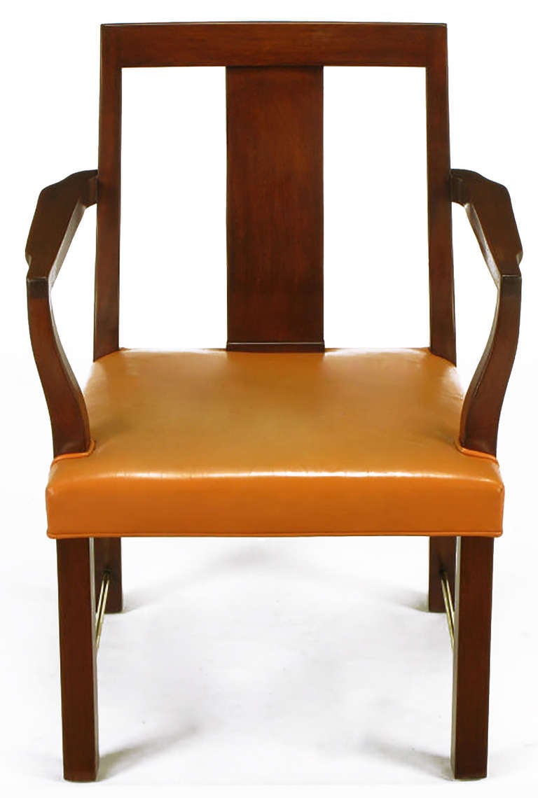 Set of eight mahogany wood and apricot leather curved panel back dining chairs by Edward Wormley for Dunbar. Set is comprised of two arm chairs and six side chairs. Rarely seen collection with brass rod stretchers.