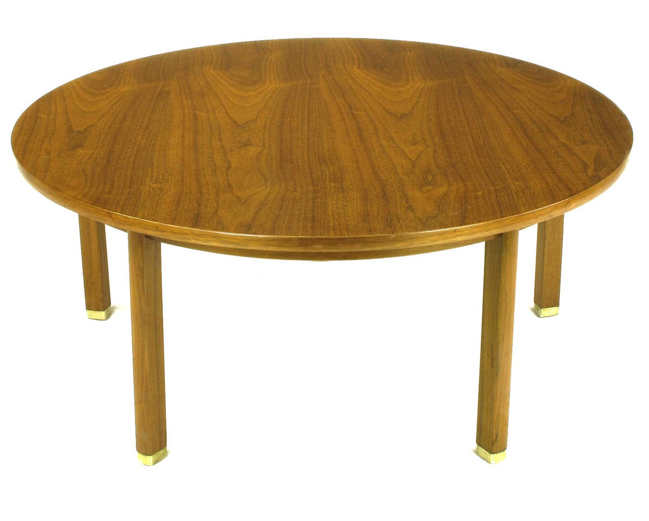 Dunbar five-leg walnut coffee table. Another uncommon Wormley design with the addition of a fifth canted leg. Excellent wood grain, recessed apron and brass sabots.