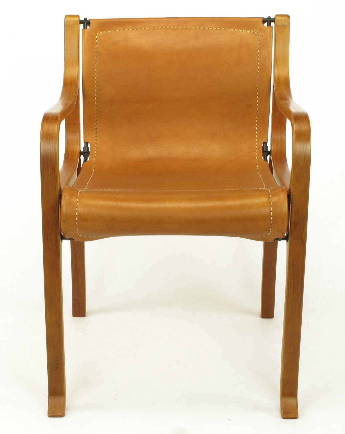 Remarkably realistic cast and hand tinted resin resembling steam bent plywood one piece arms and legs connected by black powder coated iron frame supports. High quality umber leather with white stitching.