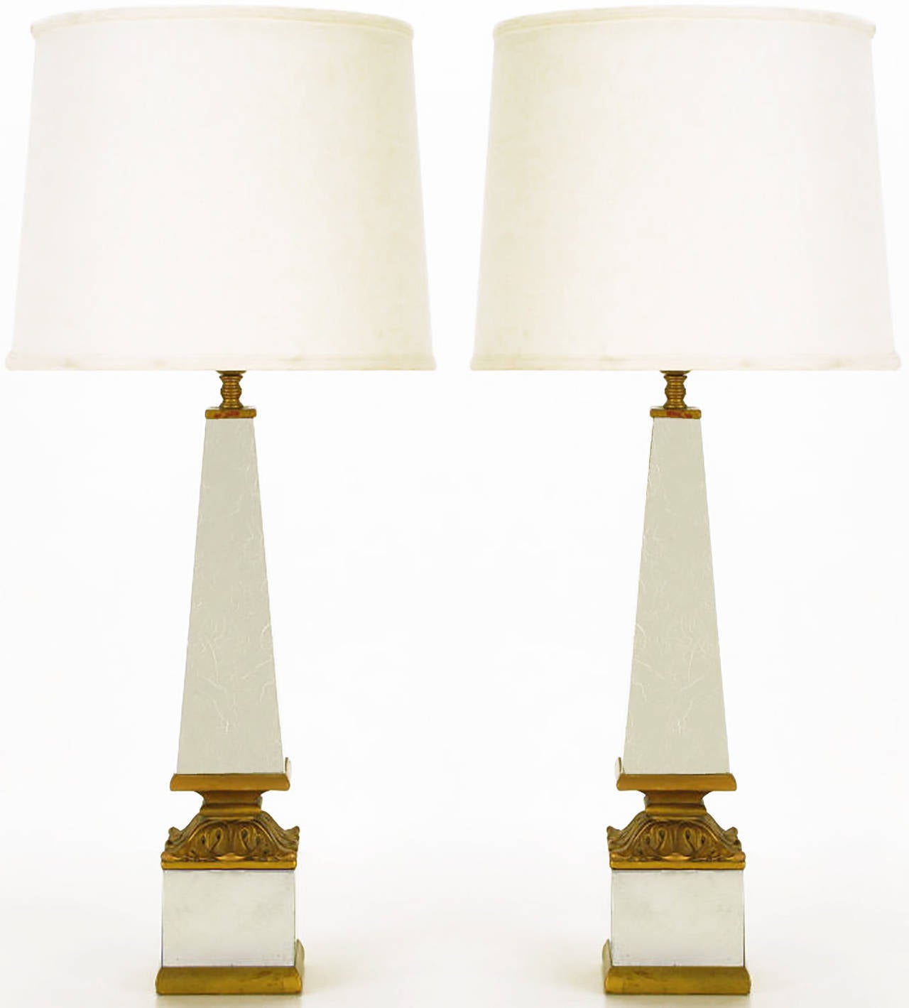 Exceptional pair of Rococo style Venetian mirror and giltwood obelisk form table lamps. Mirrored and giltwood block base with a gilt acanthus leaf cap. Veined Venetian mirrored obelisk form bodies with brass cups and milk glass diffusers.