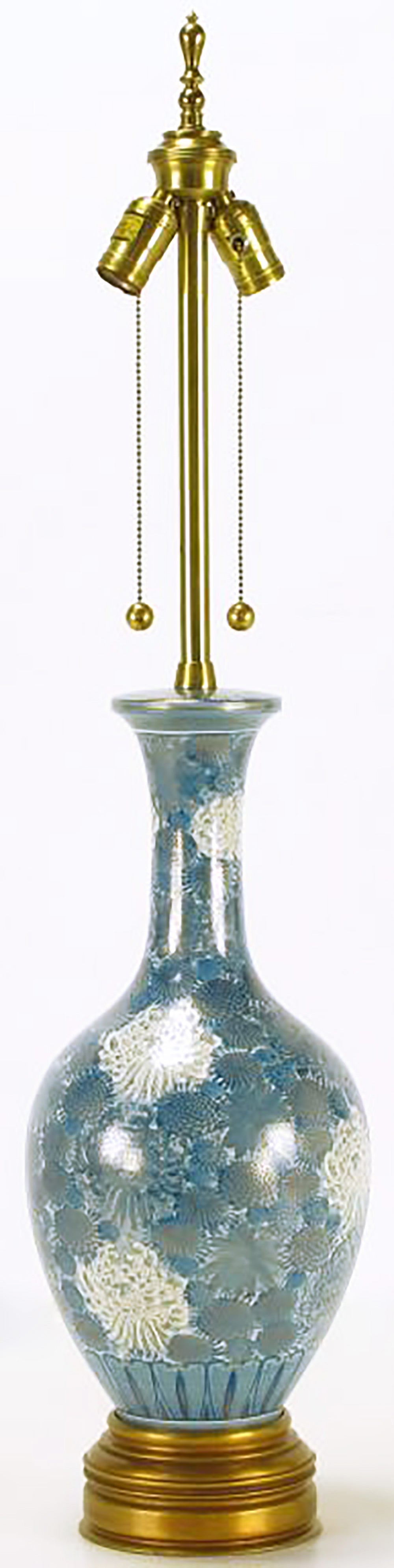 Marbro Lamp Company blue and white porcelain vase-form table lamp. Hand-painted blue and white chrysanthemums are outlined lined in gold leaf. Gilt brass base and brass stem with double socket cluster. Ball and chain pull switches. Sold sans shade.