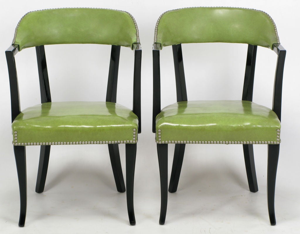 Art Deco inspired dining or game table arm chairs, finished in newly restored black lacquer.  High quality original sage green vinyl upholstery, and brass nailhead trim. Very well made and lovingly cared for.