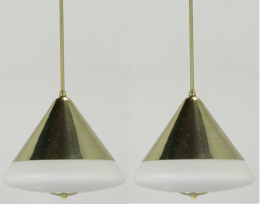 Pair of conical brass, spun gold anodized aluminum, and milk glass fixtures.  Brass self-leveling stems and ceiling canopies. Milk glass shade/diffuser attached with a brass disc and decorative nut. Manufactured by the esteemed EJS Lighting