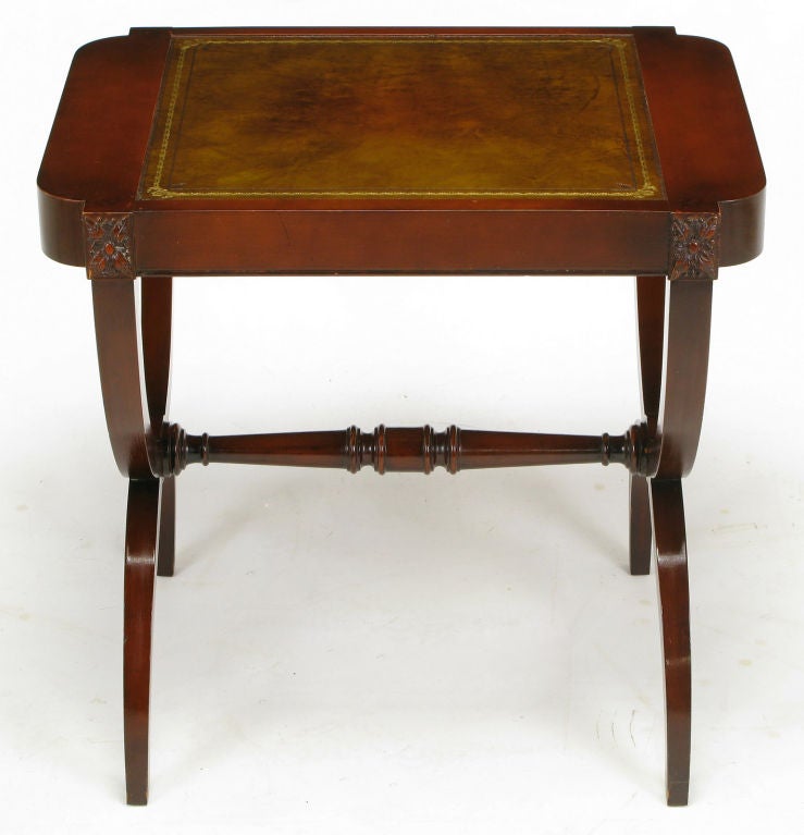Pair of mahogany end tables from quality table manufacturer Zangerle & Peterson (1892-1974) of Chicago. Legs are a curule style with center rosette at the intersection with the center carved stretcher. Top is tooled and gilt leather.  Sides have