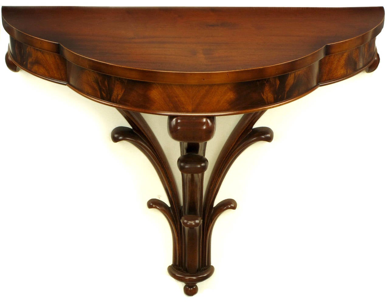 Wall-mounted demilune console table finished in exquisite crotch mahogany. Solid mahogany triple plume base in the manner of Grosfeld House. Restored to excellent condition, circa 1940.