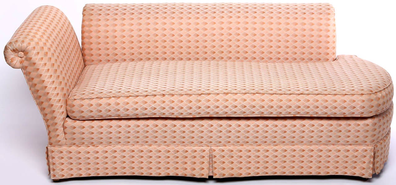 A 20th century interpretation of Madame Recamier's sofa or chaise with rounded end. Roll-form arm and back are independently mounted to the base.

Can be re-upholstered with or without the skirt as the legs are clean lined tapered dowels.