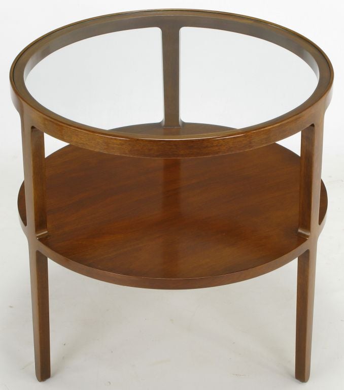 Rare offering from Edward Wormley's many designs for Dunbar. Round side table has inset glass top, with lower surface of beautifully grained walnut. on which the original finish has been very well preserved. Three legs meet each level with curved