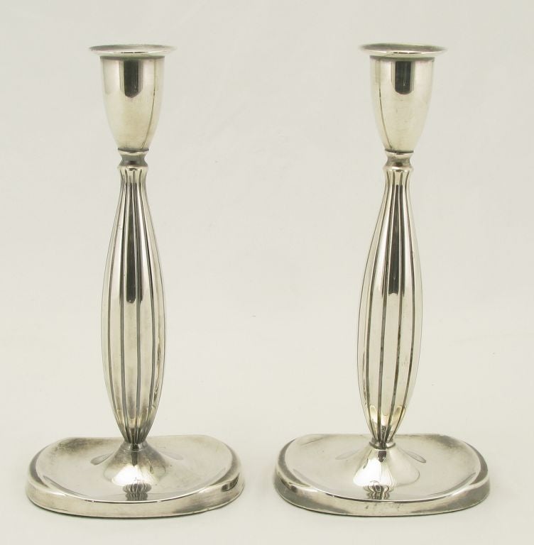 Pair of silverplated modernist fluted candle holders from Denmark. Clean lined modern look with a classic silhouette and recessed drip tray. Stamped Denmark with a silver hallmark.