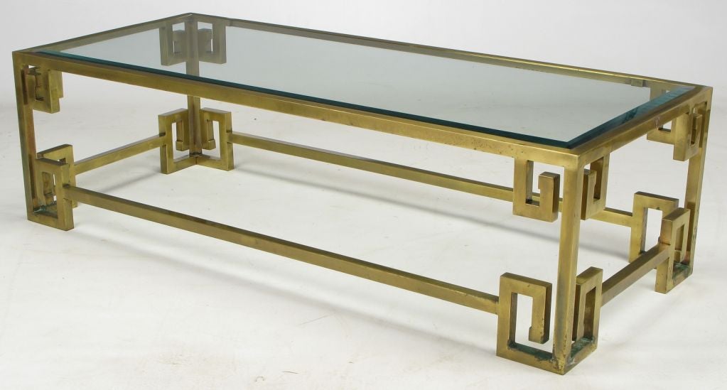 Mastercraft rectangular coffee table in brass square bar construction and Greek key design. Beveled glass top is inset. Currently offered with original aged patina.  Can be stripped and polished at buyer's expense.