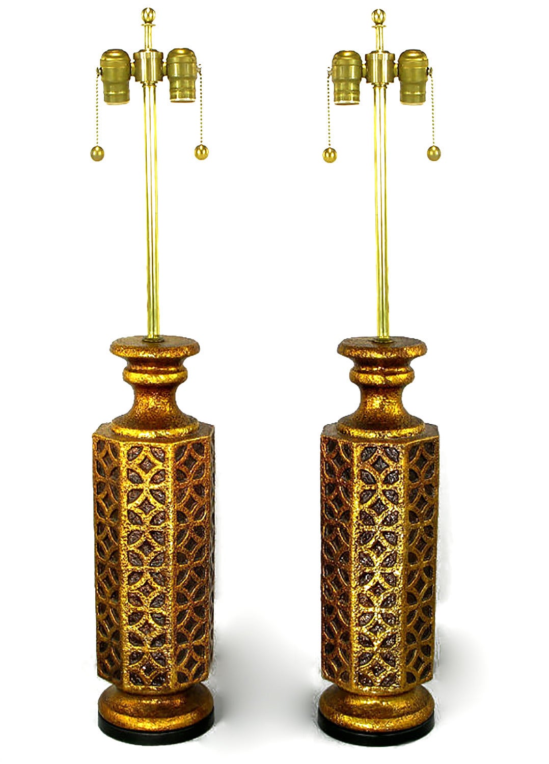 Striking pair of table lamps with eight-sided Moorish arabesque reliefs, octagonal gilt ceramic bodies and impressive size. Sold sans shades.