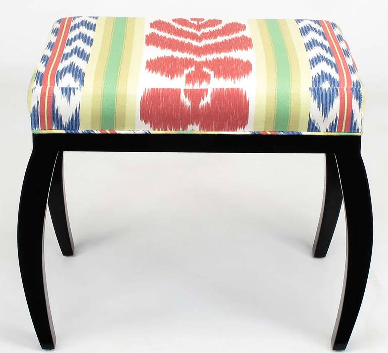 Pair of unique benches from Chicago custom furniture manufacturer to the trade, Interior Crafts. The reverse klismos style legs are elegant and unexpected. New Ikat upholstery and black lacquer over wood frames.