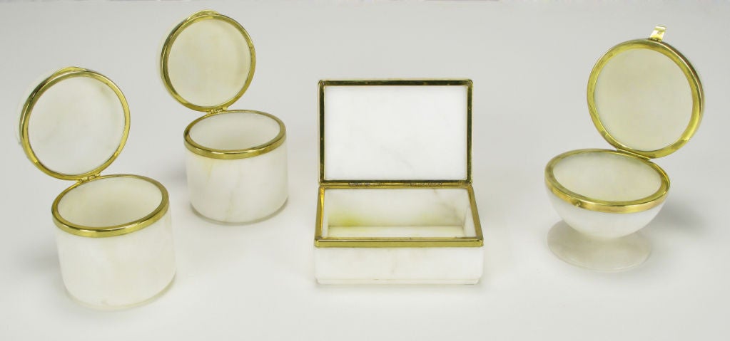 Polished alabaster and brass rim set of various shaped containers or boxes, with hinged lids. Two cylindrical jars, one rectangular box and one footed sphere.  Believed to be of Italian origin.<br />
<br />
Ball 4.5