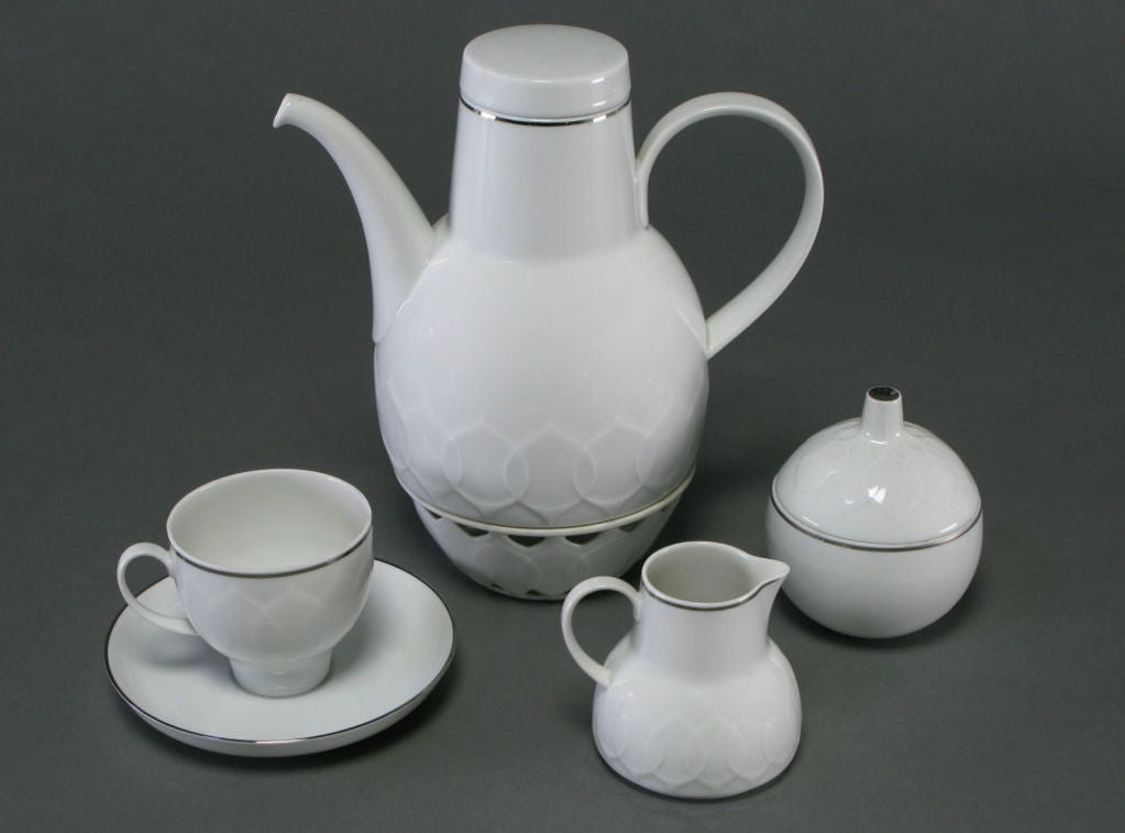 Designed by Bjorn Wiinblad in 1963 for Rosenthal China, Germany.  Porcelain dinnerware service with 12 complete place settings, each including the dinner plate, soup bowl, salad plate, bread and butter plate, dessert bowl, coffee cup and saucer.