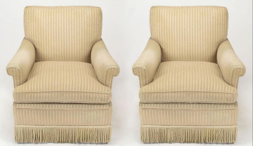 Pair of taupe cut wool stripe rolled arm club chairs in the style of vintage Kittinger of Buffalo, NY. Corded silk fringe skirt can used as is or removed. The legs are dark stained tapered walnut.