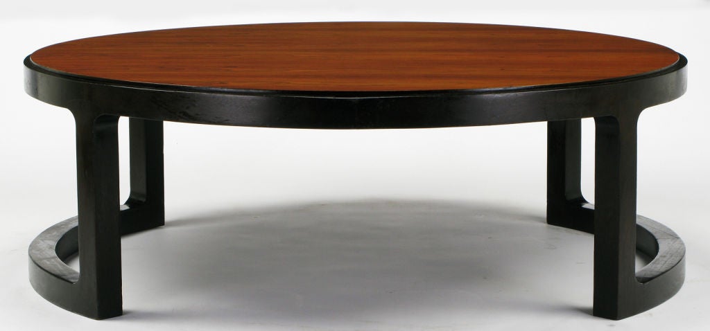 Round rosewood top coffee table with dark stained mahogany open radius U-shaped base, by Edward Wormley for Dunbar. Rosewood top is in impeccable condition as it has had a protective 3/8