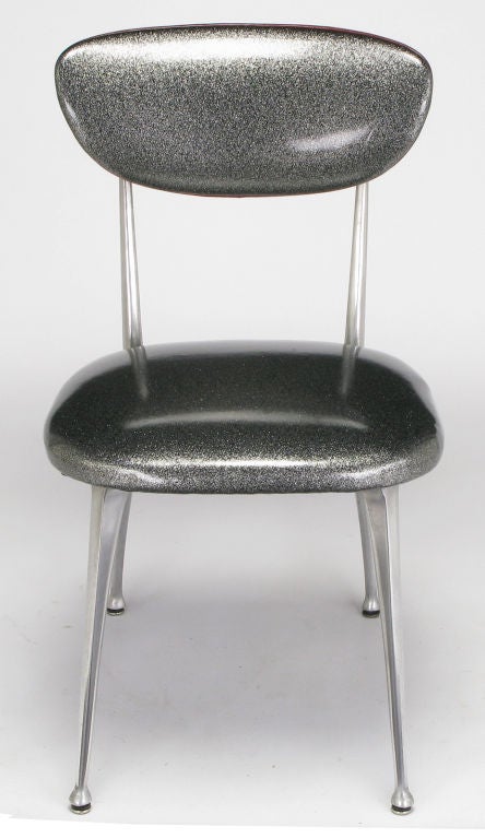 Classic 1950s impala-style side chairs in polished aluminum frames with original silver metalflake vinyl upholstery and red welting around the back rest. Striking classic modern dining or desk chairs for a small table or work area.