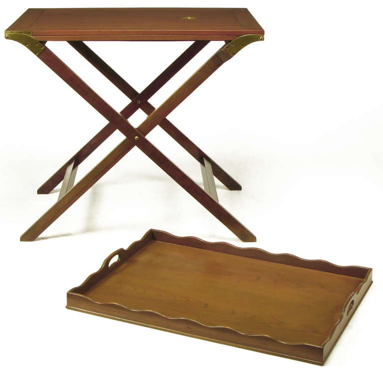 Butler tray table, with folding X-base, in original light walnut finish from Baker Furniture. Two flush panel mahogany butterfly leaves unfold from the centre on heavy brass hinges to create a 92